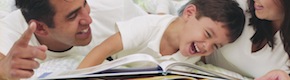 Parents Reading to Laughing Boy