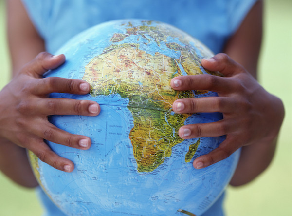 Girl's hands holding globe --- Image by © Royalty-Free/Corbis